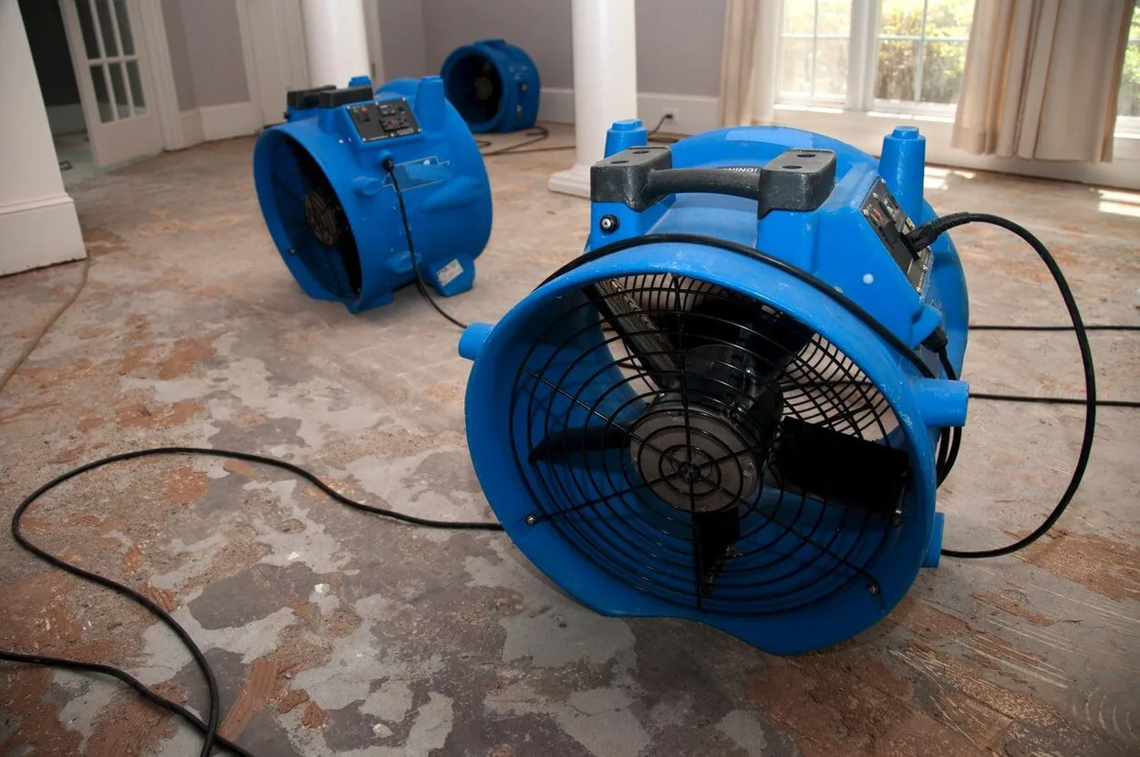 water-rem Several Large Blue Air Blowers Being Used In A Room With Damaged Flooring